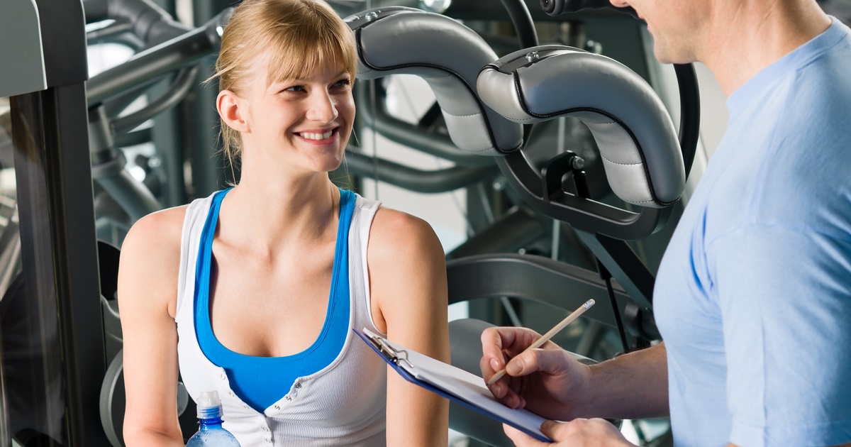 Personal Trainer providing fitness consultation to a client